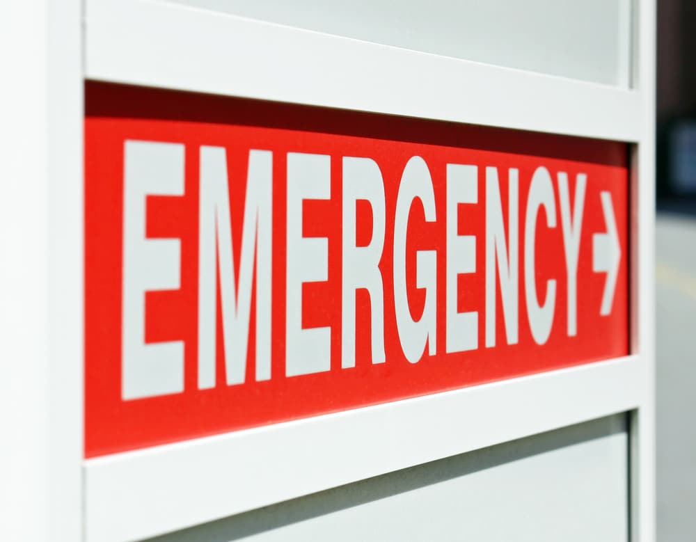A red Emergency sign at the entrance to a hospital