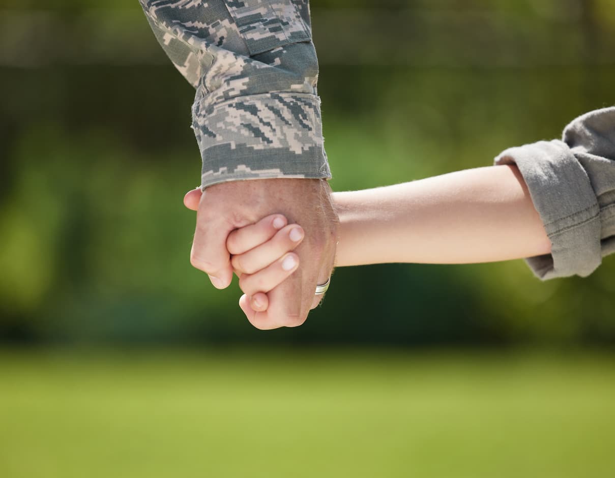 Vet holding childs hand