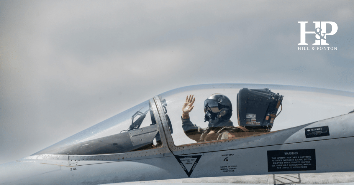 Fighter pilot waving inside jet